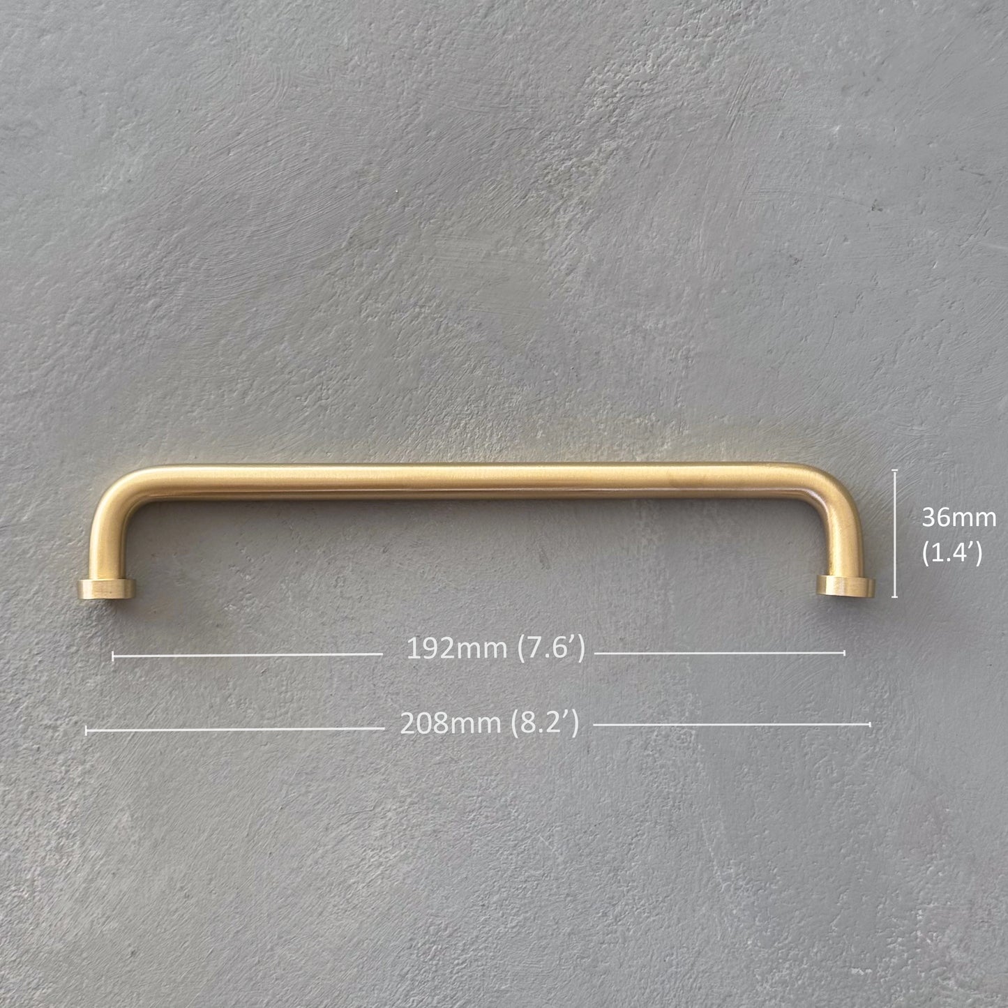 one rounded brass bar handle large size on grey background