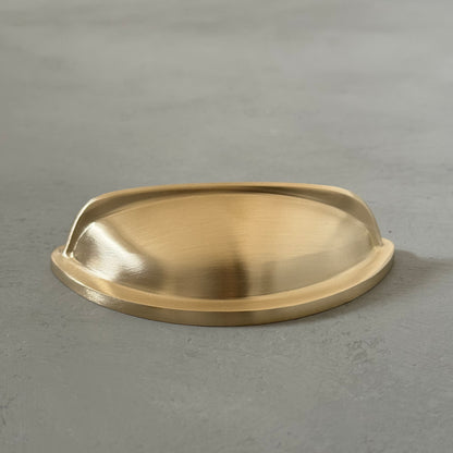 one traditional brass cup pull handle from the side