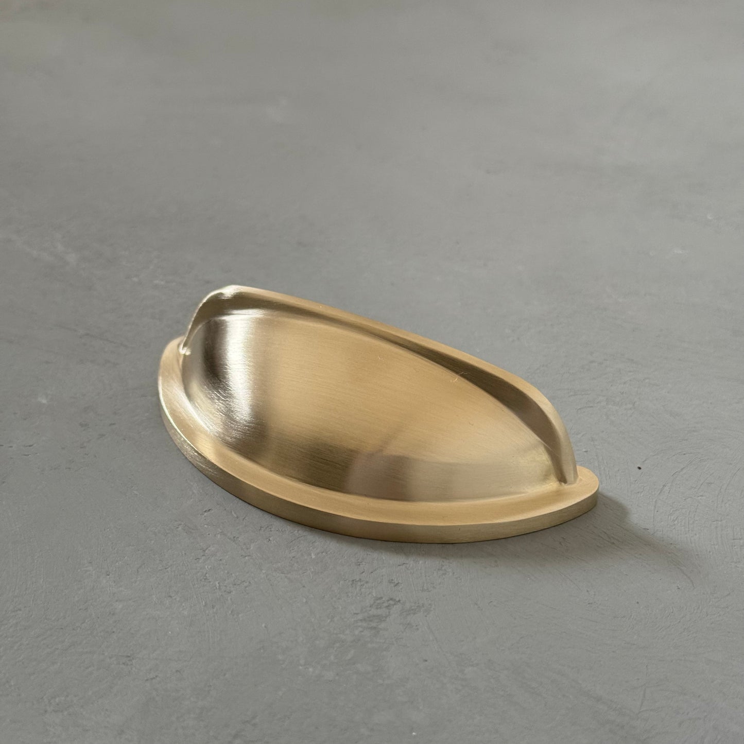 one traditional brass cup pull handle from right angle