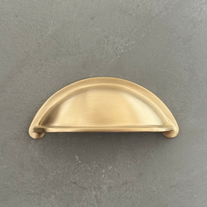 one traditional brass cup pull handle from front side