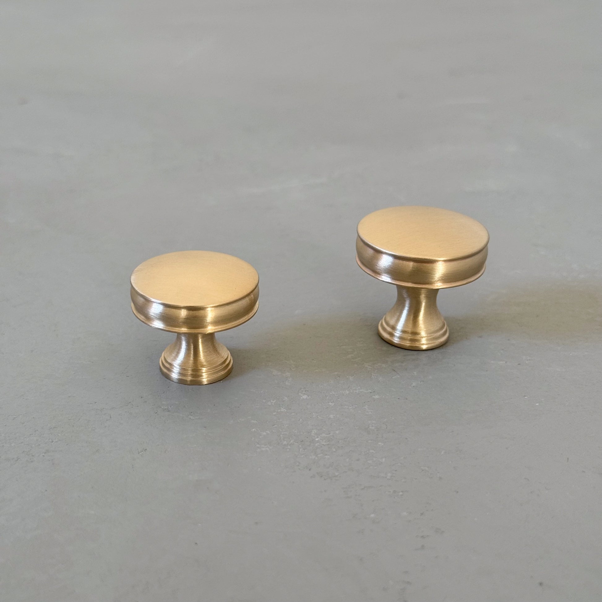 two bevel round knobs with grooves taken from front