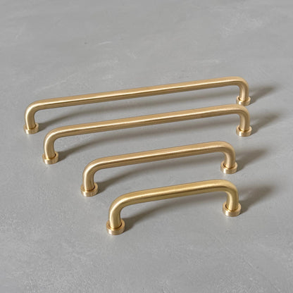 four rounded brass bar handles taken from left angle