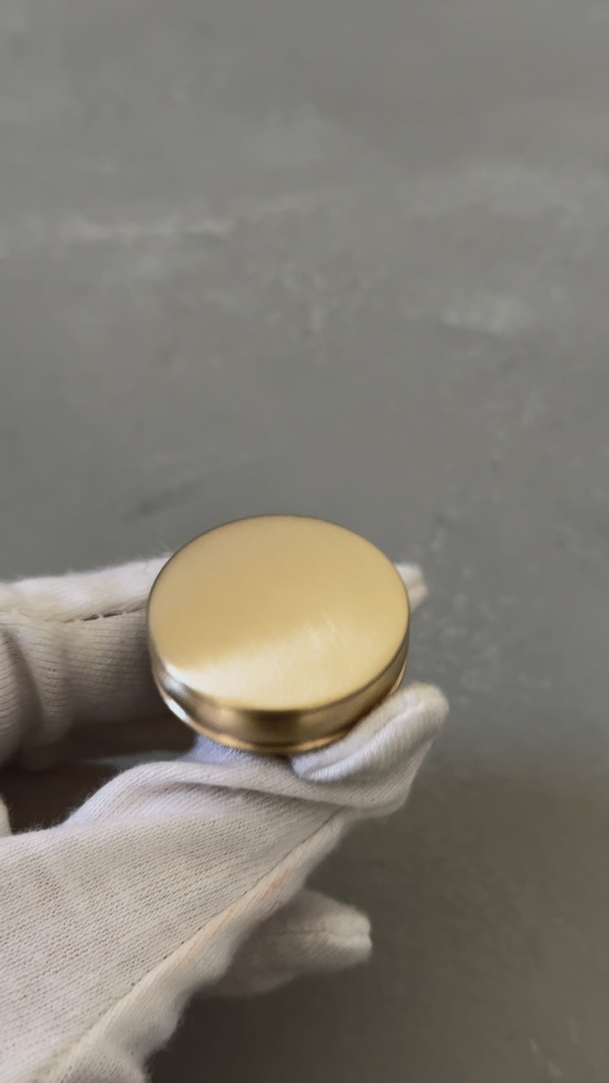 video of one bevel round knob with grooves on a white glove palm